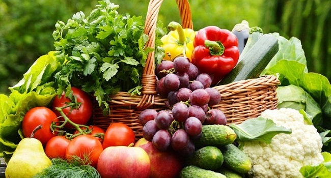 Fresh Organic Vegetables In Wicker Basket In The Garden