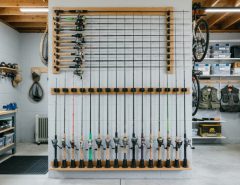Neat garage wall mount rod rack organizing fishing rods vertically.